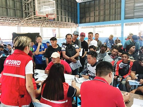 DRIVERS line up as workers from the Department of Social Welfare and Development provide cash aid amid the high cost of petrol in the country.