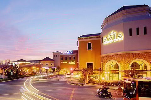 EVIA transforms at night with warm lights reflecting across the lagoon, creating a cozy and romantic atmosphere.