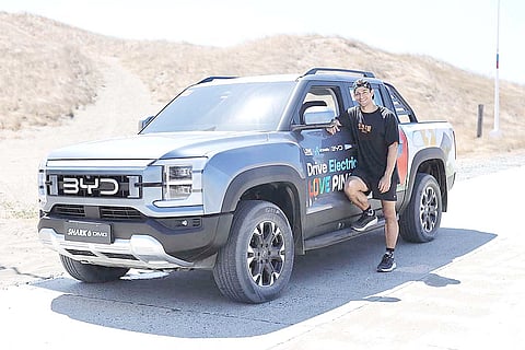 OFFICIAL lead navigator Wil Dasovich stands with the BYD Shark 6 DMO in Laoag, marking the inaugural stop of the ‘Drive Electric. Love Pinas.’ campaign.