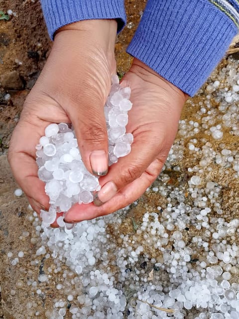 Residents of Barangay Sadsadan in Bauko, Mountain Province, observe a rare hailstorm that struck the area Tuesday afternoon. The storm, which lasted about 40 minutes, brought heavy rain and falling ice that damaged local crops and swept away farming equipment near the river.