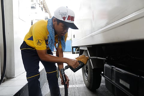 A gasoline attendant fills the tank of a commercial truck at a station in Quezon City on Wednesday.
