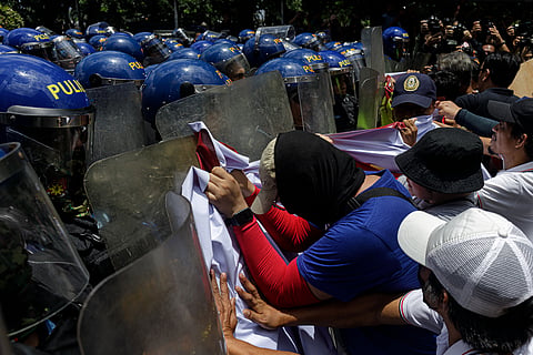 PROTESTERS clash with police during an attempt to demonstrate in front of the US Embassy in Manila. The confrontation broke out as groups marked Labor Day with calls for workers' rights and various social reforms.