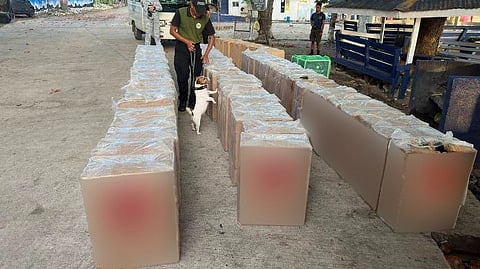 BOC-IX and PDEA personnel inspects and accounts confiscated smuggled cigarettes with navy personnel.