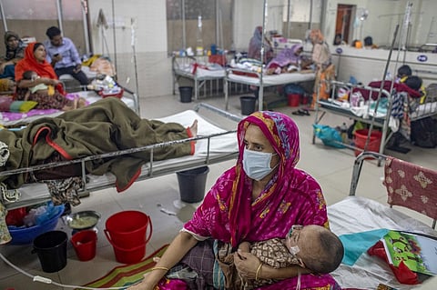 A WOMAN holds a child with measles in a pediatric ward at the Bangladesh Shishu Hospital and Institute in Dhaka. Bangladesh has reported 311 child deaths since March in one of its worst measles outbreaks in decades, government data showed.