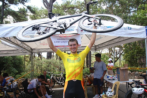 NIKITA Shulchenko lifts his bike for a triumphant celebration after ruling the MPTC Tour of Luzon on Wednesday at Camp John Hay in Baguio City.