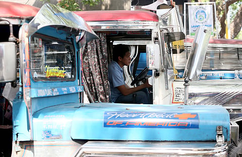 A jeepney driver patiently waits in line for passengers at a terminal in Quezon City. Public utility vehicle drivers are still reeling from the rising fuel costs the past weeks.