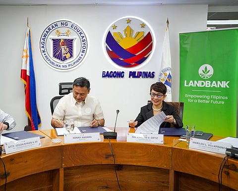 EDUCATION Secretary Sonny Angara and LandBank president and CEO Ma. Lynette Ortiz sign a memorandum of agreement on Thursday to launch a loan take-out program for Department of Education personnel.