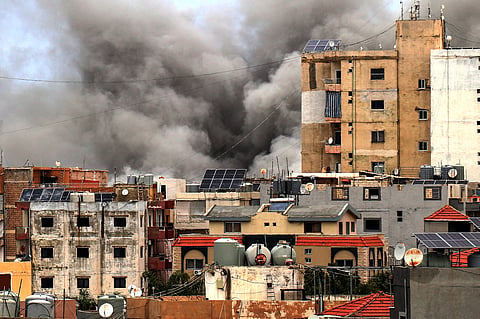 SMOKE rises behind buildings following an Israeli airstrike in the southern city of Tyre on 15 May 2026.