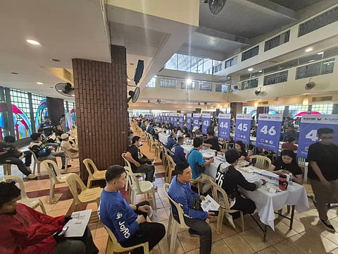 Joyride drivers lined up to receive ₱5,000 cash assistance from the government at the Bahay ng Alumni, UP Diliman, on Saturday, May 16. (Photo from: DSWD)