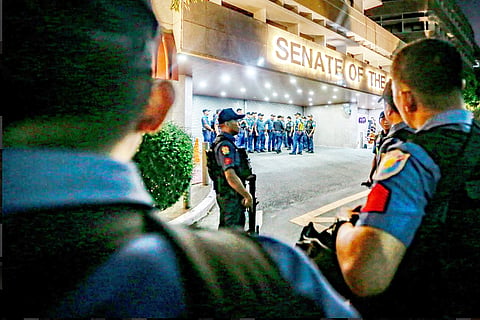 PHALANX Police keep rival protesters for and against Dela Rosa apart while Senate security personnel brace for any eventuality within the complex.