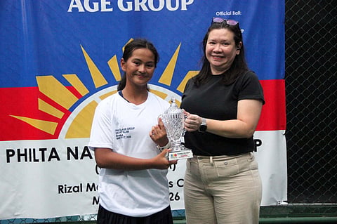 SHANER Gabaldon (left) gets feted by Philta executive director Tonette Mendoza after winning the girls’ U14 event of the Philta National Age Group Championships on Monday at the Rizal Memorial Tennis Center.