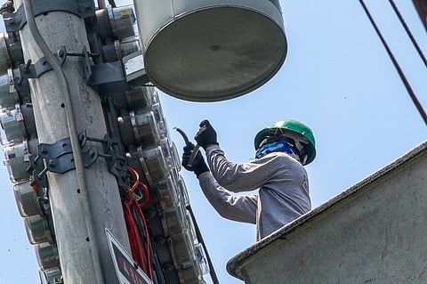 NEW power meters are being installed by a Manila Electric Company technician in Tondo, Manila on Tuesday.