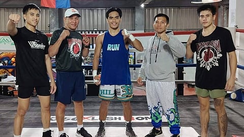 KENNETH Llover (middle) exudes confidence in the presence of camp mates (from left) sparmate Jeff Santos, trainers Carl Peñalosa Jr. and Dindo Campo and sparmate Perlito Exclamada at the Spartan Warehouse Gym in Tagaytay City.