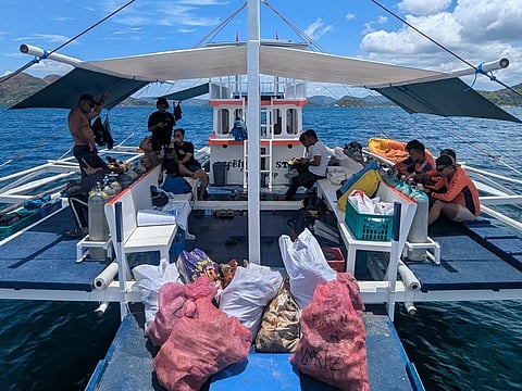 Volunteer divers rest after collecting marine trash in Coron, Palawan as part of the nationwide simultaneous coastal and underwater clean-up for 2026 Month of the Ocean Celebration on Thursday, May 21. Photo courtesy of Richard Novelo | Calamianes Dive Association Inc.
