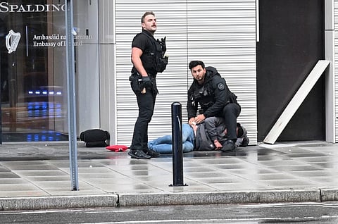 WHITE House chaos Secret Service agents assist a wounded man after a shooting near the White House in Washington, D.C., on Saturday. The gunman was killed.