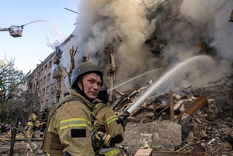 FIREFIGHTERS work to extinguish a fire at the site of a heavily damaged building following Russian strikes to the Ukrainian capital in Kyiv on 24 May 2026, amid the Russian invasion of Ukraine.