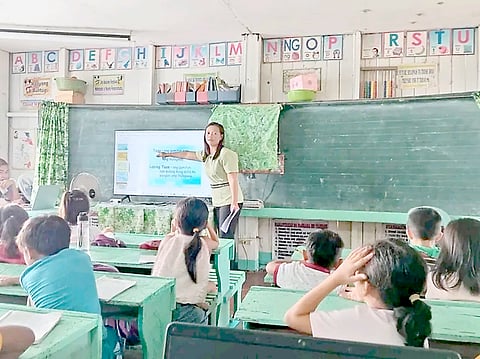 TEACHER Irene P. Ayala during a Grade 2 class at the Dinagat Elementary School in Barangay San Marcos, Bunawan, Agusan del Sur. The additional P10-million donation will help equip 12 last-mile schools with digitalization systems powered by solar energy and satellite Internet.