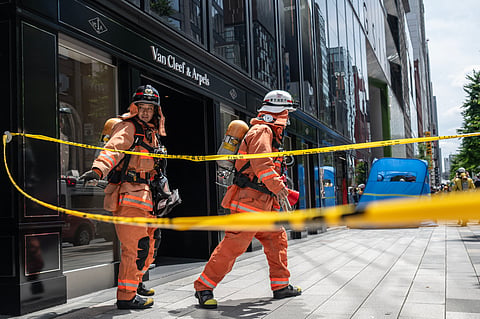 FIREFIGHTERS go past police tape to the entrance of the Ginza 6 Shopping Center in Tokyo on 25 May 2026, after an individual allegedly sprayed a substance in the area.