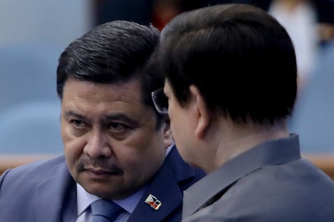 Senators Jinggoy Estrada and Rodante Marcoleta huddled at the Senate Plenary session on Tuesday, 26 May, after it was announced by the Office of the Ombudsman that a case of plunder would be filed against the latter over his supposed involvement in the multibillion peso flood control scandal.