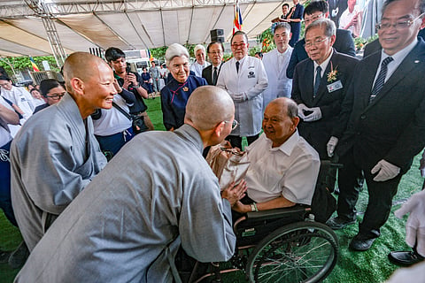 BUDDHIST nuns representing Tzu Chi Foundation in Taiwan greet Liwayway Group chairman Carlos Chan (in wheelchair), whose family donated the land where the Tzu Chi Imus Eye Center will rise.