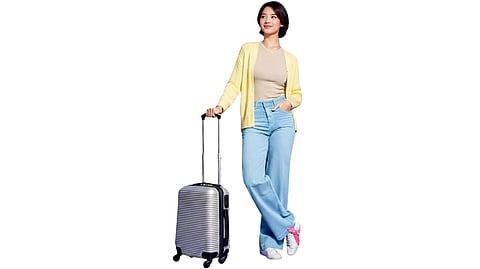 A TRAVELER poses with a suitcase in a promotional image for The Great BDO Travel Sale.