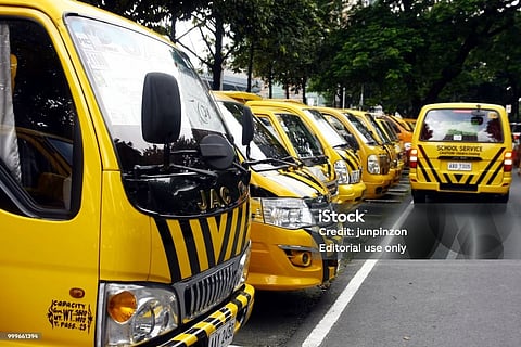 Quezon City, Philippines - September 6, 2016: School service vehicles line up and wait to fetch students at a parking lot of a school (PHOTO from iSTOCK)