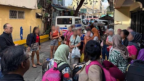 OFFICIALS from the Department of Migrant Workers lead a simultaneous raid to rescue 206 aspiring migrant workers trapped in overcrowded, illegal housing facilities in Manila and Imus, Cavite.
