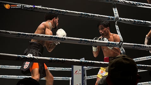 Kenneth Llover holds his own against a taller Michael Angeletti in their IBF bantamweight title eliminator in Japan.
