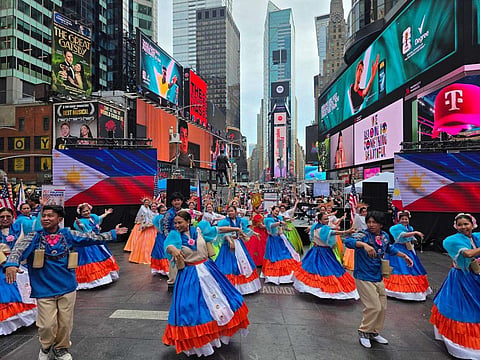 UNDER billboards built to sell things, Filipino dancers spent an afternoon selling culture, bringing festival rhythms and centuries-old traditions to the crossroads of Manhattan.