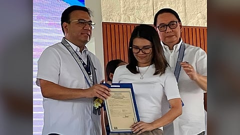 KEY to future Department of Human Settlements and Urban Development Secretary Jose Ramon Aliling (left) and Social Housing Finance Corp. president Federico Laxa (right) hand over a land title to a resident of Sta. Rita, Pampanga, advancing the Expanded 4PH Program’s promise of community-driven homeownership through the Enhanced Community Mortgage Program.