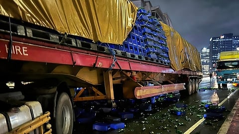A TRAILER truck sits crushed after slamming into a stalled vehicle on the southbound lane of the C5-Ortigas Flyover late Saturday night. The crash claimed the life of a truck helper, who remained trapped inside the mangled cab for more than three hours before rescue teams could extricate him.