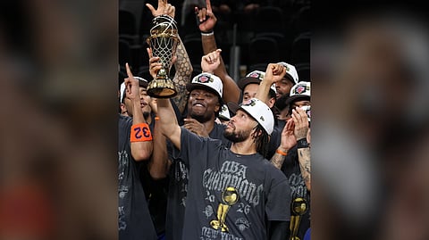 JALEN Brunson proudly hoists the MVP trophy after leading the New York Knicks to their first NBA crown in 53 years.