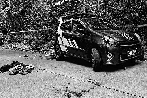 POLICE cordon off the site of a deadly ambush in Barangay Salvacion, Albuera, Leyte, on Monday. The shooting left two dead and three wounded. A manhunt is currently underway for the unidentified gunman who fled into a nearby mountainous area.