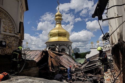UKRAINIAN firefighters work at the roof of the damaged Dormition Cathedral in the Orthodox complex of the Kyiv Pechersk Lavra following a Russian missile and drone strike in Kyiv.