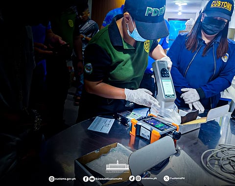 BUREAU of Customs officials inspect bags containing approximately 505 grams of suspected shabu, valued at P3.43 million, at the Central Mail Exchange Center at NAIA.