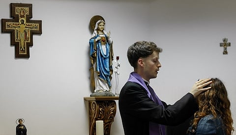 SELF-PROCLAIMED priest, not recognized by the Catholic Church, Francisco Marques, 27, places his hands on a woman’s forehead, during a ‘exorcist retreat’ where he claims to cast out demons afflicting his followers, organized by the Prelature of Saints Peter and Paul in Fatima on 30 May 2026.