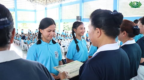 TZU Chi Bohol volunteers present the scholarship certificates to beneficiaries.