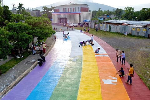 VOLUNTEERS painting the road in ranbow colors on 5 June.