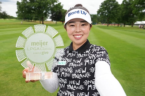MIYU Yamashita poses with the trophy after winning the Meijer LPGA Classic For Simply Give 2026 at Blythefield Country Club.
