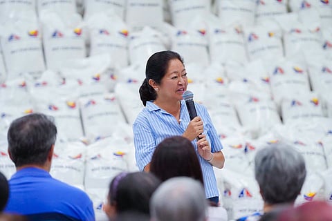 FIRST Lady Liza Araneta-Marcos spends time with residents of Tondo, Manila, during a rice distribution activity aimed at assisting families in the community. Marcos said the initiative was a simple gesture to help provide food and comfort to households in need.