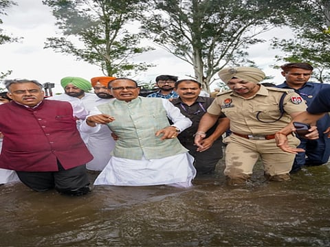 Union Minister in knee-deep floodwaters in Punjab fields