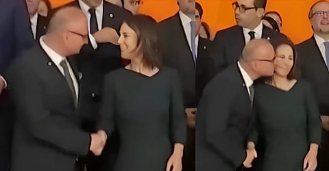 Croatia's Gordan Radman tries to kiss German Foreign Minister Annalena at EU conference