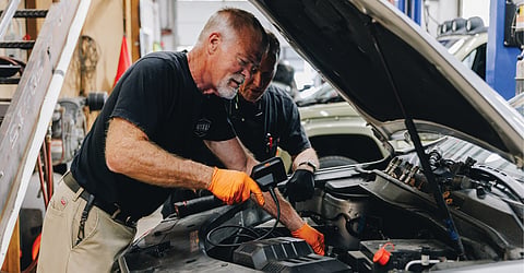 Gerry Reisert and Steve Fromhold ready a donated car for a new owner.