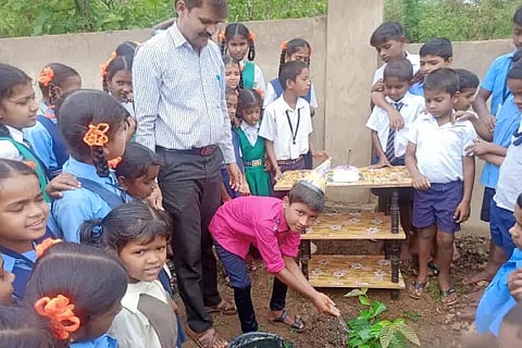 Govt School Children Celebrating birthday in front of Plant.