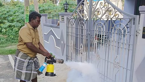 Employee on the job of spraying mosquito repellent