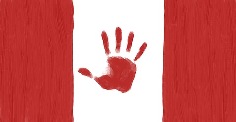 A Canadian flag with a painted hand.