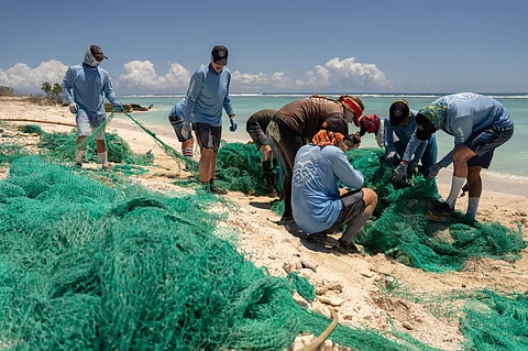 Marine Debris Technicians from the Papahānaumokuākea Marine Debris Project removing ghost nets from Kuaihelani (Midway Atoll) on April 23, 2024.