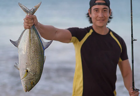 Hawaiian fisherman with his catch.