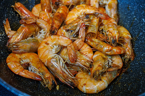Freshly cooked Ecuador white prawns in butter and garlic.