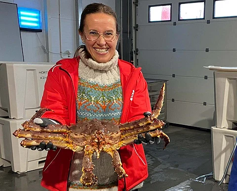 Marianne Sivertsen Næss, Norway's Minister of Fisheries and Ocean Policy, holds a king crab.